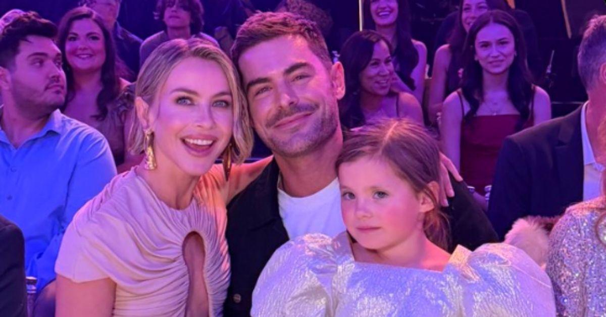 image of Olivia and Zac Efron looked relaxed as they cheered for their brother.